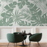 Papier peint Motif de feuilles tropicales, tons verts doux.