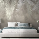 Papier peint Motif de feuilles tropicales dans des tons doux.