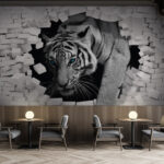 Papier peint Tigre traversant un mur de briques blanches.