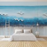 Papier peint Peinture d'oiseaux volant au-dessus d'un océan bleu