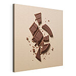 Tableaux Barre de chocolat cassée sur une surface rose